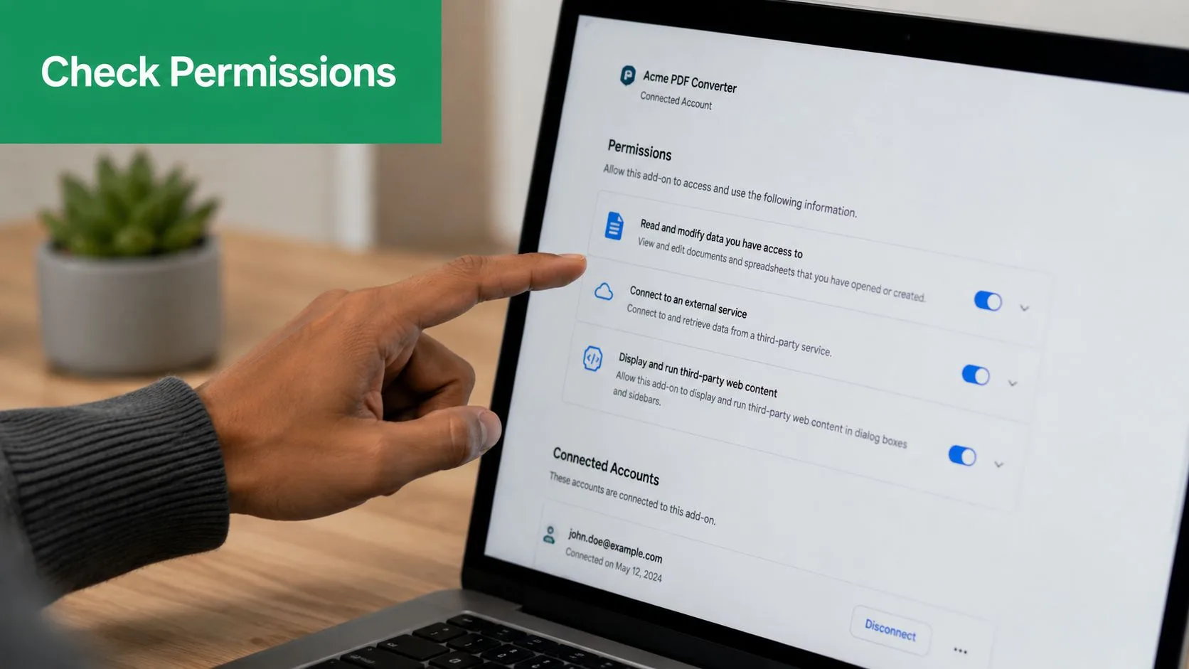 A person checking the security permissions settings for a connected PDF converter add-on on a laptop screen.